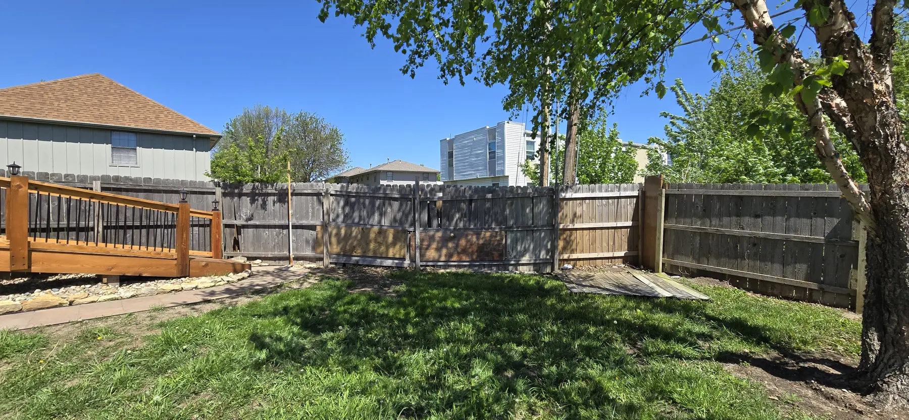 Weathered and leaning backyard fence before replacement in Belton