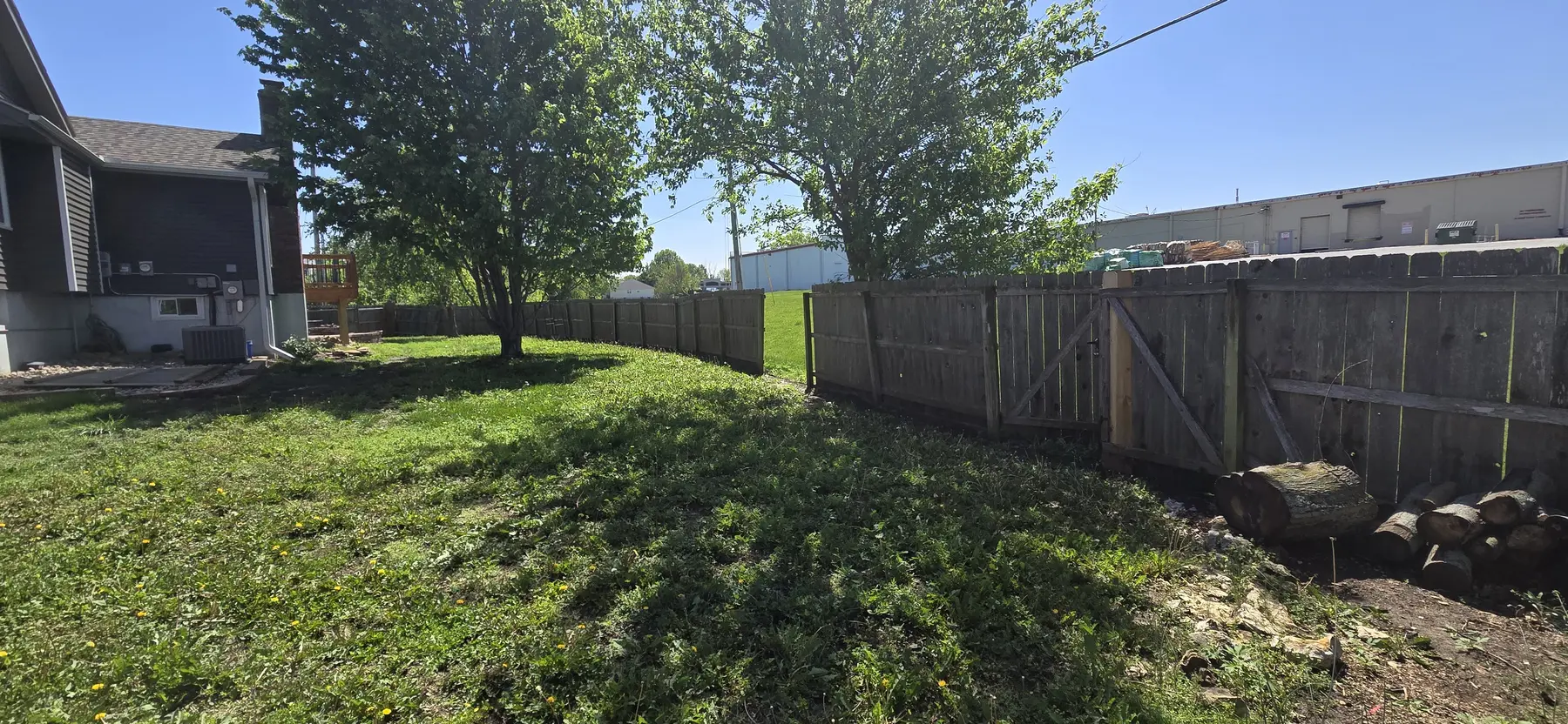 Wide view of the original backyard fence before replacement