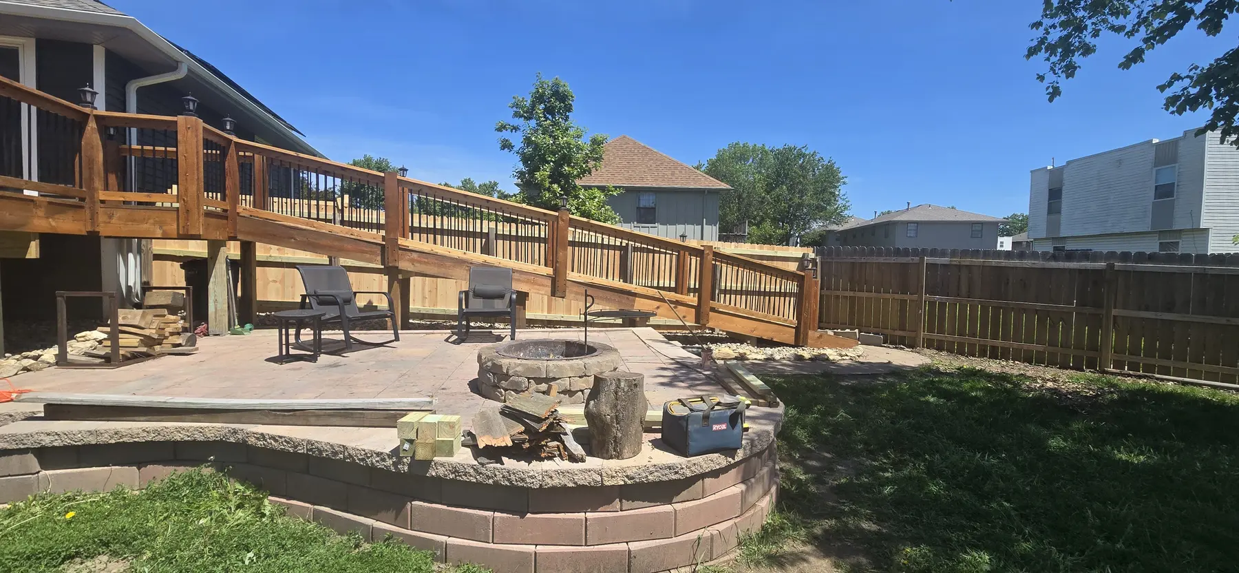 Completed cedar fence beside an existing backyard deck