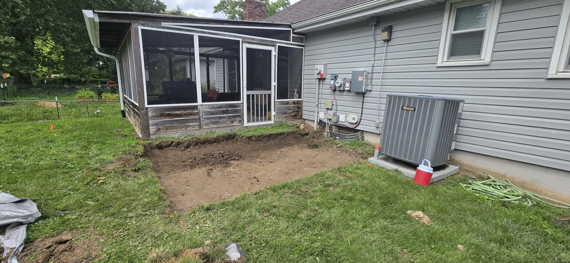 Excavated patio area beside a screened porch in Belton