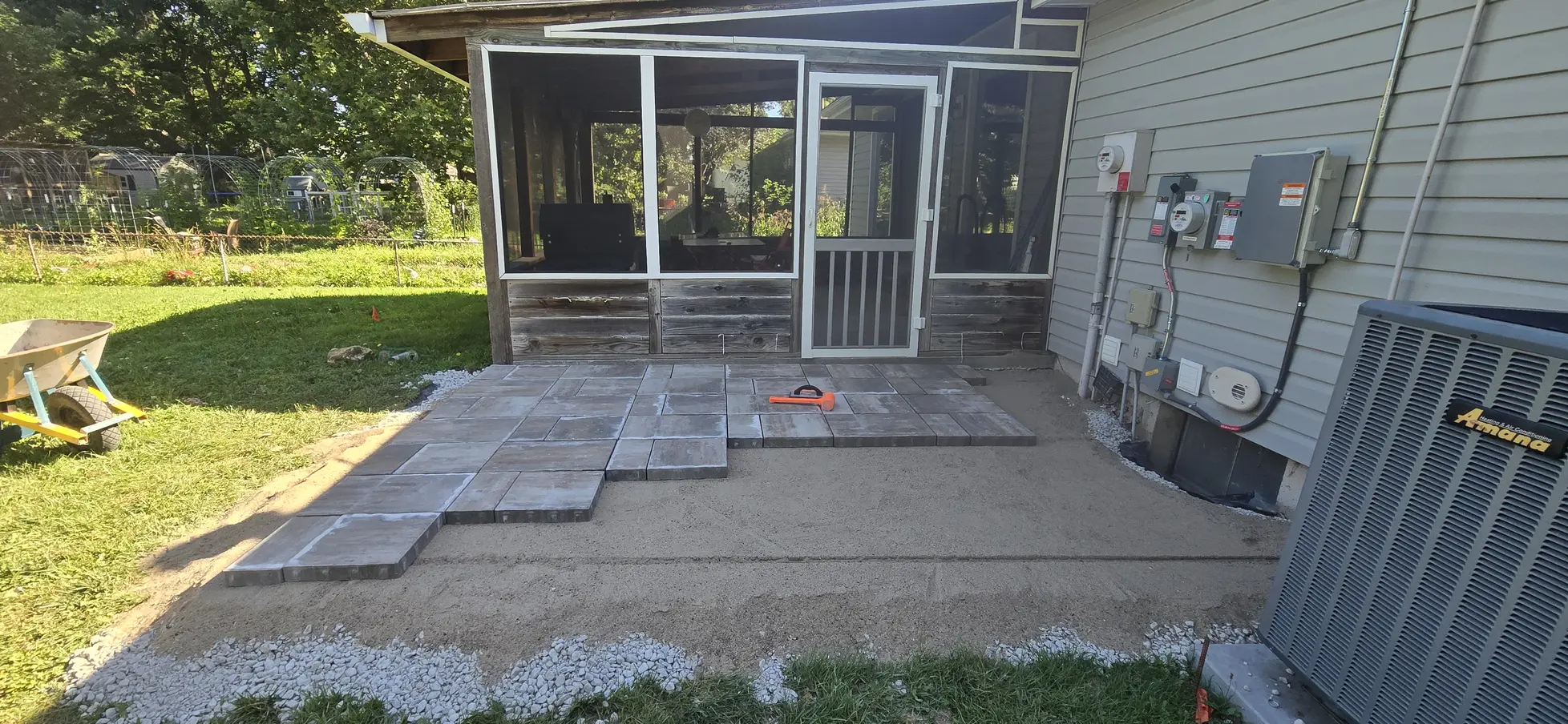 Unilock pavers being installed over the prepared patio base
