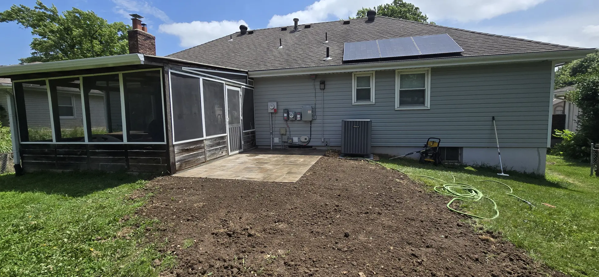 Finished screened-porch paver patio and regraded yard in Belton, Missouri