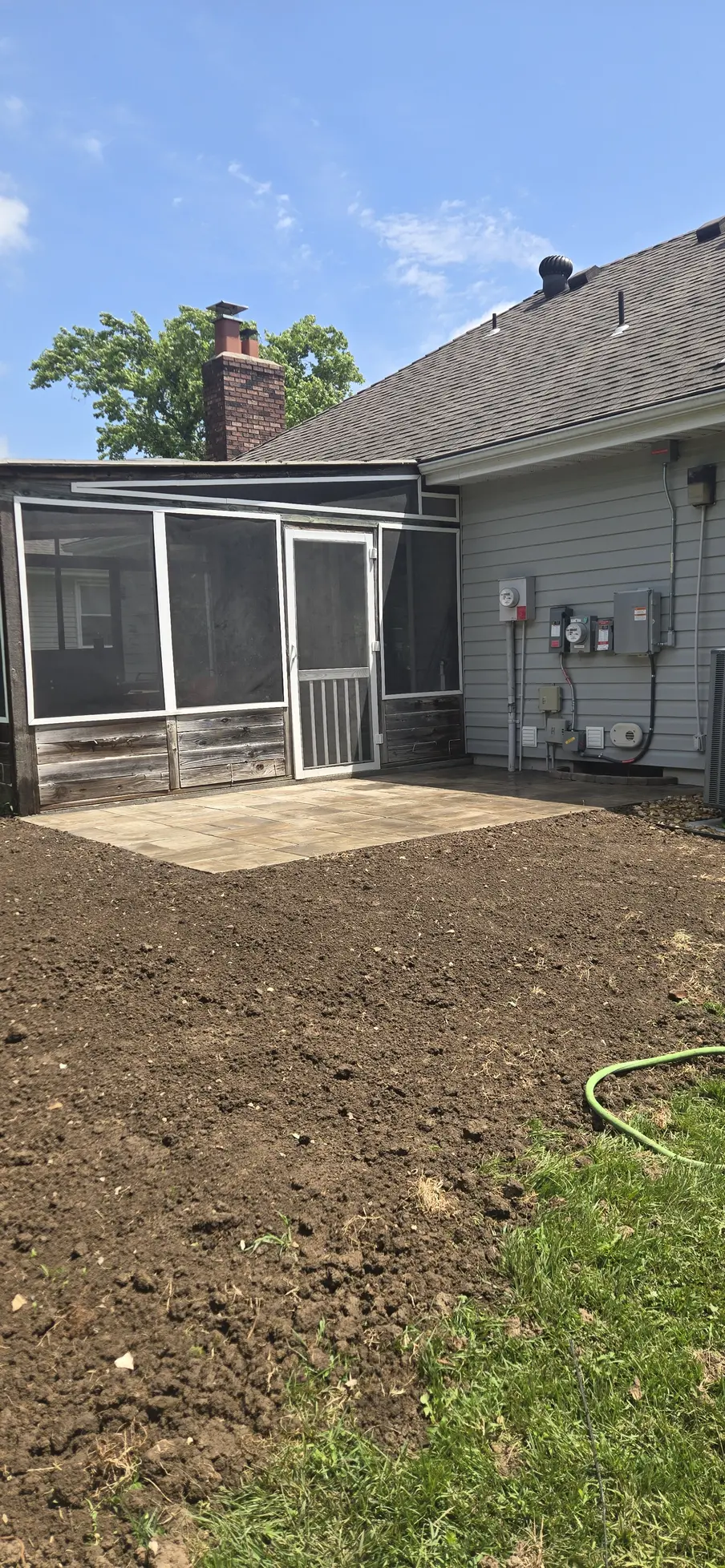 Finished 15-by-9-foot paver patio outside a screened porch