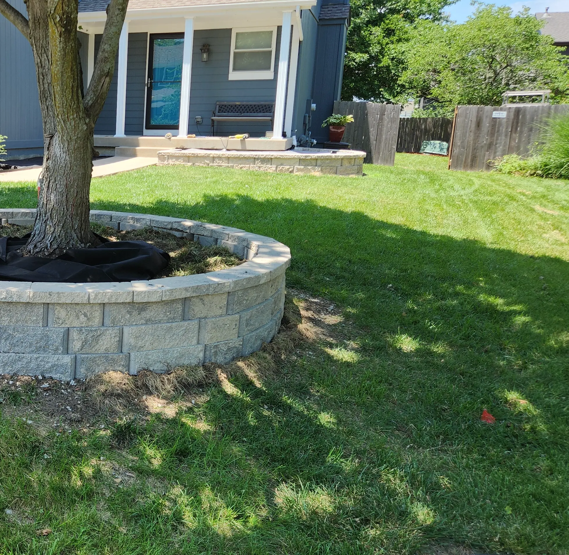 Block tree ring with landscape fabric during construction